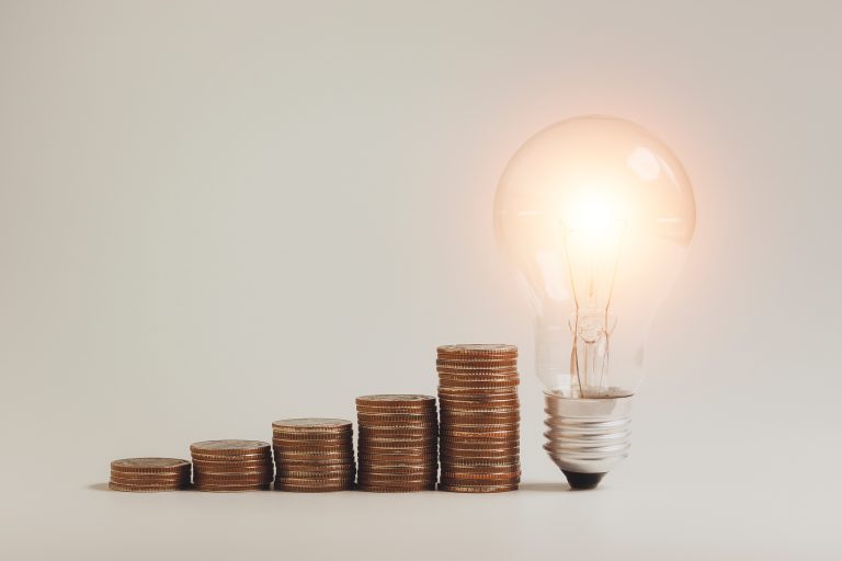 LED light bulbs and stacking of money coins, ideas for energy sa